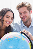Happy couple looking at a globe