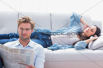 Woman laid on a couch listening to music