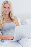 Blonde woman using her laptop