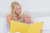 Mother reading a story to her daughter