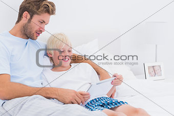 Father and his son using a tablet