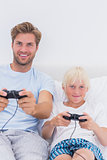 Happy father and son playing video games