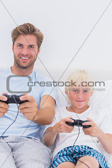 Happy father and son playing video games