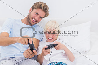 Cheerful father and son playing video games
