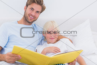 Handsome father reading a story to his son