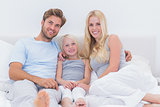 Portrait of a beautiful family in the bed