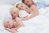 Beautiful couple sleeping with their children
