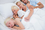 Couple sleeping with their cute children