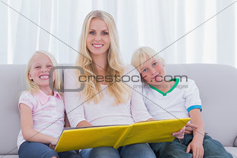 Portrait of a mother reading a story to children