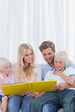 Cheerful family reading a story together