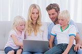 Portrait of a family using a laptop
