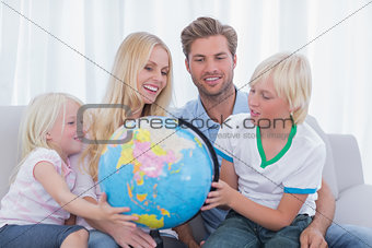 Family looking at globe together