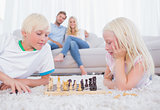 Cute siblings playing chess