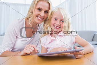 Mother and daughter using tablet pc together