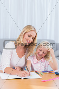 Smiling mother drawing with her daughter