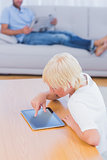 Boy using tablet at table in the living room