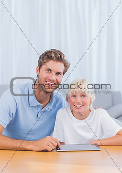 Father using tablet with his son