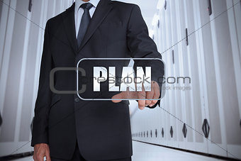 Businessman in a data center selecting label with plan