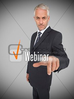 Businessman selecting the word webinar