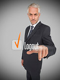 Businessman selecting the word logout