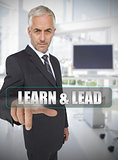 Businessman touching the term learn and lead