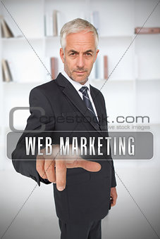 Businessman touching the term web marketing