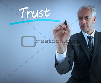 Businessman writing the word trust
