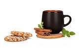Black tea cup with cinnamon and cookies on white background