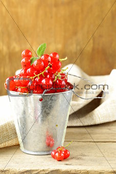 Organic ripe red currant on a wooden table