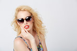 Trendy blond woman posing with sunglasses
