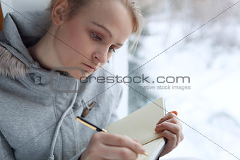 Young girl writing in her journal.
