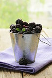 organic ripe black berry raspberry (blackberry) on a wooden table