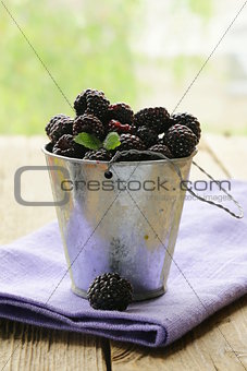 organic ripe black berry raspberry (blackberry) on a wooden table