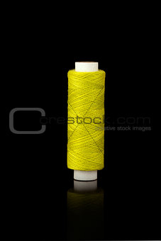 Yellow spindle of yarn
