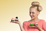 smiling girl showing cupcakes 