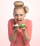 surprised girl offering cupcakes 