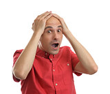 Shocking man holding his head over white background