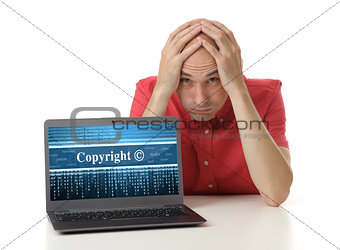Frustrated man with laptop. Copyright concept