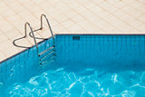 Swimming pool with metal ladder 