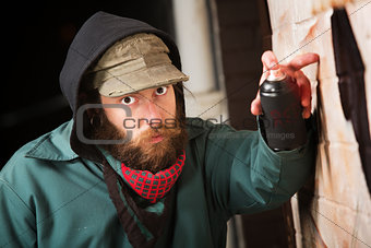 Hooded Man Tagging a Wall