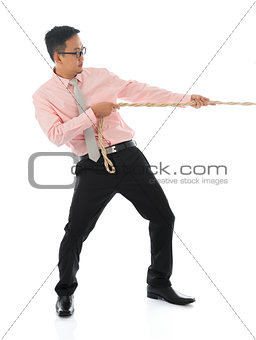 Asian businessman pulling a rope 