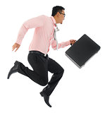 Asian businessman running or jumping