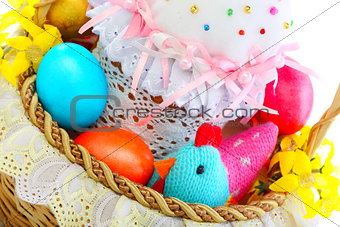 Easter cake and eggs in a basket.