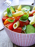 pasta salad with cucumbers, tomatoes and basil