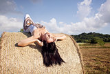 Beautiful woman laying on hay
