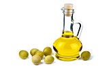 Small decanter with olive oil and some olives near