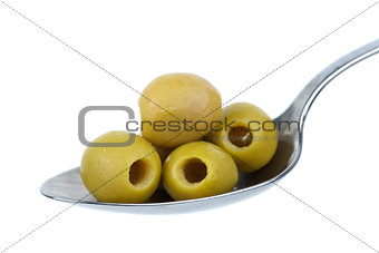 Five marinated pitted green olives in the metal spoon