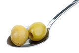 Two marinated pitted green olives in the small metal spoon