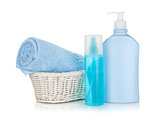 Cosmetics bottles and blue towel