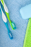 Toothbrushes and soap over towels